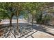 Large backyard featuring a shaded patio area, mature trees, and ample space at 4825 Stillwater Ave, Las Vegas, NV 89110