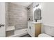 Modern bathroom features stylish gray tiling, a frameless shower with a built-in seat, and a sleek vanity at 4825 Stillwater Ave, Las Vegas, NV 89110