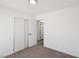Simple, carpeted bedroom showcasing a door leading to other areas of the house at 4825 Stillwater Ave, Las Vegas, NV 89110
