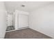 Bright bedroom features a neutral color scheme, plush carpet, and a closet with sliding doors at 4825 Stillwater Ave, Las Vegas, NV 89110