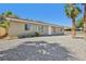 Low angle view of a one story home with rock landscaping and white trim at 4825 Stillwater Ave, Las Vegas, NV 89110