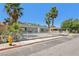 Full front view of a one story home with desert landscaping and mature trees at 4825 Stillwater Ave, Las Vegas, NV 89110