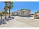 Street view of single-story home showing a long drive and desert landscaping at 4825 Stillwater Ave, Las Vegas, NV 89110