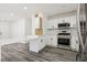 Bright kitchen featuring modern appliances, white cabinetry, and a convenient breakfast bar setup at 4825 Stillwater Ave, Las Vegas, NV 89110