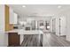 Bright modern kitchen features new stainless-steel appliances, stylish countertops, and wood-accented breakfast bar at 4825 Stillwater Ave, Las Vegas, NV 89110