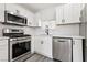 Close-up of updated kitchen appliances and cabinetry with modern design details at 4825 Stillwater Ave, Las Vegas, NV 89110