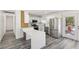 Modern kitchen featuring white cabinets, stainless steel appliances, and breakfast bar area, flooded with natural light at 4825 Stillwater Ave, Las Vegas, NV 89110
