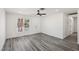 Bright living room with modern gray flooring, fresh paint and large window at 4825 Stillwater Ave, Las Vegas, NV 89110