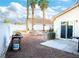 Backyard view featuring palm trees, a grill, and a white block wall at 4848 Cutting Diamond Ct, North Las Vegas, NV 89081