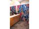 Stylish bathroom with a wood cabinet and colorful patterned shower curtain at 4848 Cutting Diamond Ct, North Las Vegas, NV 89081