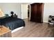 Bedroom featuring wood floors, neutral walls, and a spacious closet at 4848 Cutting Diamond Ct, North Las Vegas, NV 89081