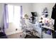 Bright bedroom with a desk and a modern workstation setup with a chair at 4848 Cutting Diamond Ct, North Las Vegas, NV 89081