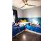 Shared ' room with twin beds and colorful cartoon character decor accents at 4848 Cutting Diamond Ct, North Las Vegas, NV 89081