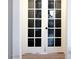 Elegant white french doors featuring glass panels and a classic black handle at 4848 Cutting Diamond Ct, North Las Vegas, NV 89081