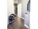Hallway with modern wood-look floors, neutral paint, and an arched doorway at 4848 Cutting Diamond Ct, North Las Vegas, NV 89081