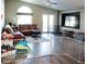 Bright living room with wood floors, vaulted ceiling, and access to the backyard at 4848 Cutting Diamond Ct, North Las Vegas, NV 89081