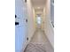 Hallway with tiled flooring that leads to a half bathroom at 4993 Birchland Manor Ave, Las Vegas, NV 89139