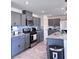Kitchen boasts gray cabinets, stainless appliances, granite counters, and tile backsplash at 4993 Birchland Manor Ave, Las Vegas, NV 89139