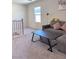 Comfortable living area with staircase, modern seating, and black coffee table at 4993 Birchland Manor Ave, Las Vegas, NV 89139