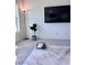 Bright living room features a marble-top coffee table, tv and house plant at 4993 Birchland Manor Ave, Las Vegas, NV 89139