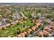 Panoramic aerial shot showcases a golf course community with lush green fairways and well-maintained homes at 5033 Austrian Dr, Las Vegas, NV 89130
