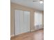 Bedroom with hardwood floors, closet with bi-fold doors, and a window at 5033 Austrian Dr, Las Vegas, NV 89130
