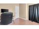Bedroom showing the hardwood floors, a dark desk and a black curtain at 5033 Austrian Dr, Las Vegas, NV 89130