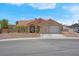Single-story home with a tile roof, desert landscaping, and an attached two-car garage at 5033 Austrian Dr, Las Vegas, NV 89130