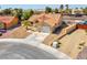 Exterior view of a single-story home featuring desert landscaping, a two-car garage, and tile roof at 5033 Austrian Dr, Las Vegas, NV 89130