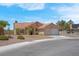 Single-story home with a tile roof, desert landscaping, and an attached two-car garage at 5033 Austrian Dr, Las Vegas, NV 89130