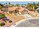 Front exterior of home featuring desert landscaping, a tile roof and a two-car garage at 5033 Austrian Dr, Las Vegas, NV 89130