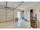 Garage featuring overhead door, utility closet, and lots of storage at 5033 Austrian Dr, Las Vegas, NV 89130