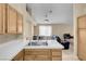 Bright kitchen showcasing a double sink, tile countertops, and wooden cabinets at 5033 Austrian Dr, Las Vegas, NV 89130