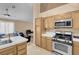 Well-lit kitchen featuring white countertops and stainless steel oven and microwave at 5033 Austrian Dr, Las Vegas, NV 89130