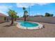 Backyard swimming pool with desert landscaping, mature palms, and privacy walls at 5033 Austrian Dr, Las Vegas, NV 89130