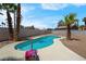 Backyard swimming pool surrounded by mature palm trees and desert landscaping at 5033 Austrian Dr, Las Vegas, NV 89130