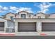 Townhouse-style home features a private two-car garage and a well-maintained exterior with stone accents at 530 Sonoma Range St, Las Vegas, NV 89138