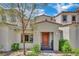 Charming home featuring xeriscape landscaping and a lovely orange front door at 530 Sonoma Range St, Las Vegas, NV 89138
