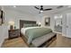 This main bedroom features an ensuite bath, modern ceiling fan, and wood look flooring at 530 Sonoma Range St, Las Vegas, NV 89138