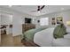 This main bedroom features an ensuite bath, modern ceiling fan, and light, wood-look flooring at 530 Sonoma Range St, Las Vegas, NV 89138