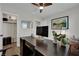 A home office features a dark wood desk, modern decor, and a ceiling fan for a comfortable workspace at 530 Sonoma Range St, Las Vegas, NV 89138