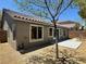 Home's backyard features a small patio and low maintenance landscaping at 5600 Nimes Ave, Las Vegas, NV 89141