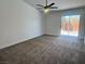 Empty carpeted bedroom features a sliding glass door providing backyard access at 5600 Nimes Ave, Las Vegas, NV 89141