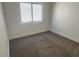 Empty carpeted bedroom features one window and neutral walls at 5600 Nimes Ave, Las Vegas, NV 89141