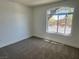 A carpeted bedroom features a large window providing natural light at 5600 Nimes Ave, Las Vegas, NV 89141