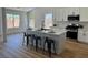 Bright kitchen featuring an island with bar seating, white cabinets, and stainless steel appliances at 5600 Nimes Ave, Las Vegas, NV 89141