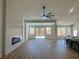 Spacious living room with modern fireplace, wood floors, and a sliding glass door to the backyard at 5600 Nimes Ave, Las Vegas, NV 89141