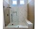 Stylish shower with marble and wood-look tile, dual shower heads, a built-in bench, and a niche at 5600 Nimes Ave, Las Vegas, NV 89141