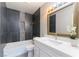 Modern bathroom featuring a sleek vanity, elegant mirror, and stylish tiled shower and tub at 5800 Auborn Ave, Las Vegas, NV 89108