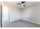 Bright bedroom with gray wood-look flooring, ceiling fan and a doorway to the hall at 5800 Auborn Ave, Las Vegas, NV 89108